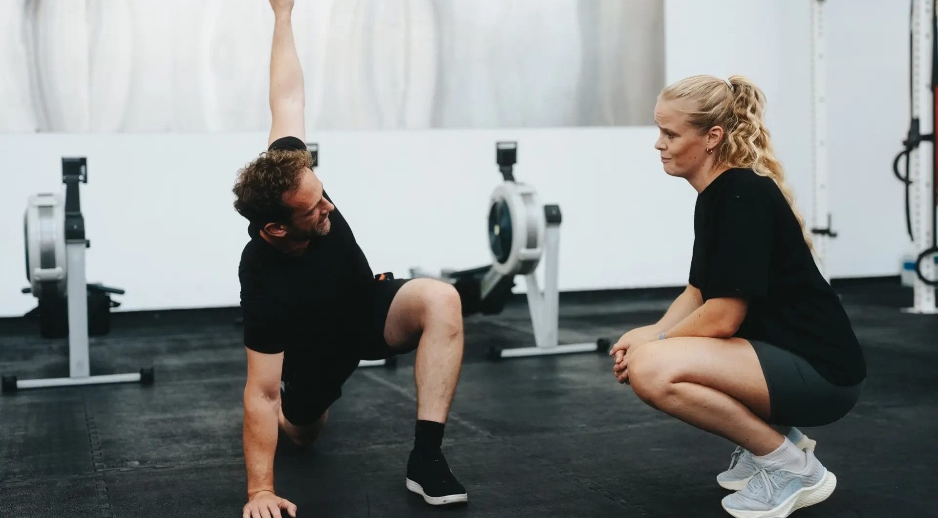 man stretching with his trainer