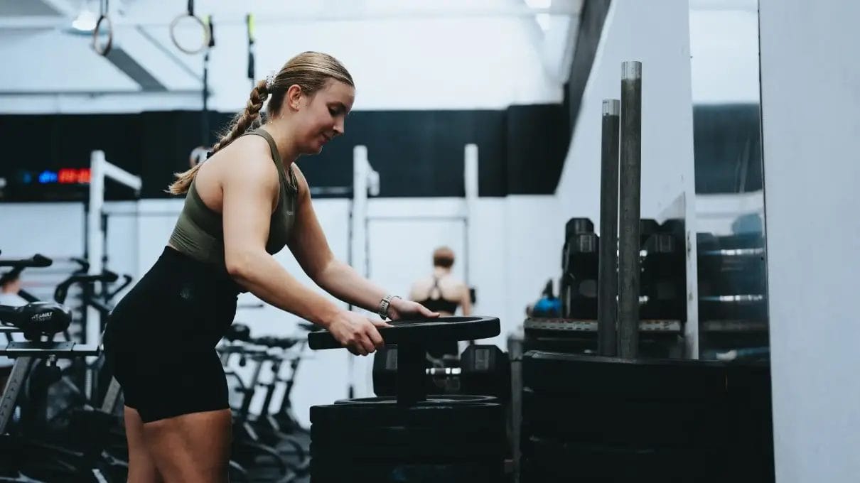 Woman taking weights